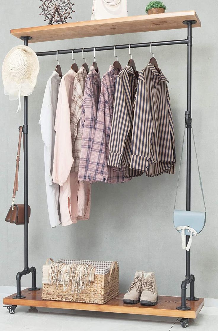 an ironing rack with clothes hanging on it