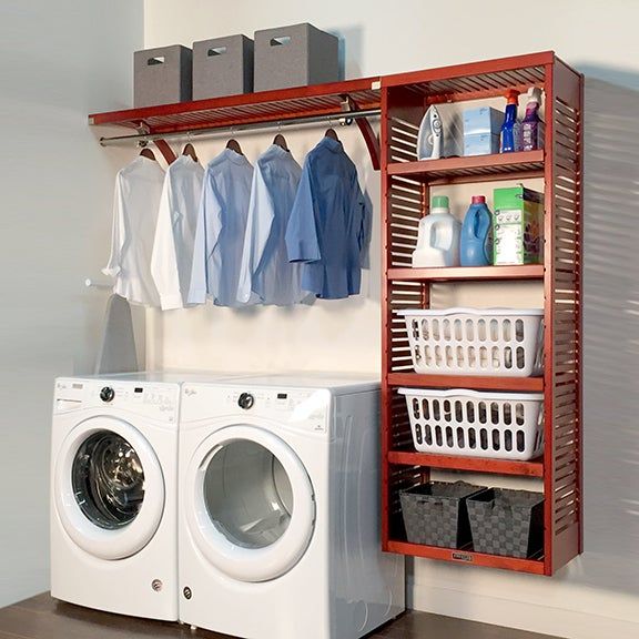 a washer and dryer sitting next to each other in front of a wooden shelf