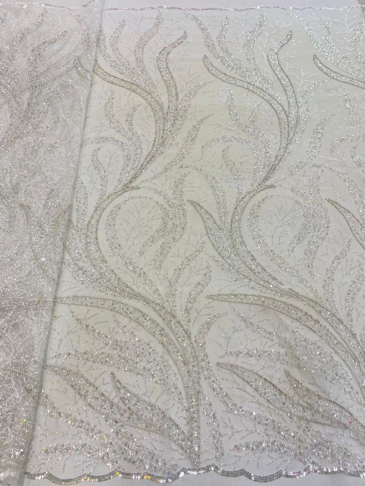 This high quality Fabric is measured in 5 Yards With Embroidered Beading and Sequin. It is soft, very delicate and beautiful. This high Quality Fabric is made with Fashion embroidered rhinestones can be used in making party wedding dresses, skirts, shawls, scarves and other other fashion apparels as you would like. Size : Length : 5 yards (180 inch). Width: 50 inch (Please allow slight deviation for the measurement data ,±1 inch) Material: 100% Polyester, Tulle Lace Fabric, Eco-Friendly embroide Elegant Cream Tulle Fabric With Sequins, Elegant Cream Sequin Fabric For Wedding, Elegant Cream Sequin Fabric With Pearl Embroidery, Elegant Sequined Fabric For Festive Occasions, Elegant Cream Embroidered Fabric For Reception, Elegant Cream Embroidered Fabric With Sequins, Elegant White Sequin Fabric For Festive Occasions, Elegant Cream Fabric For Party, Elegant Silver Embroidered Fabric For Festive Occasions