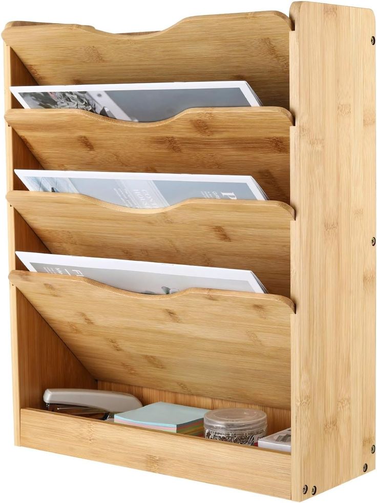 a wooden desk organizer with three compartments for magazines and folders, on an isolated white background