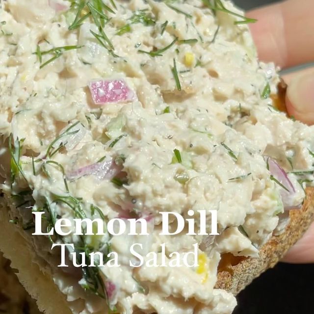 a person is holding a sandwich with tuna salad on it and the words lemon dill tuna salad