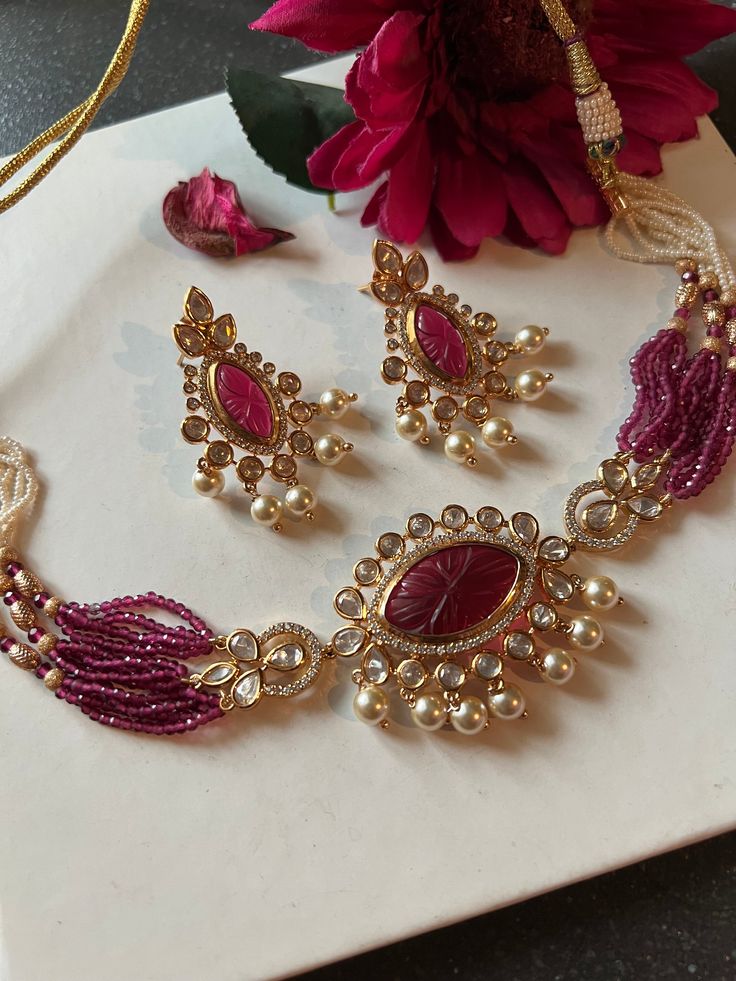 Embrace vintage elegance with our Red Kundan Choker and Earrings set. Crafted from brass and adorned with red carved stones, this captivating ensemble exudes timeless charm. Perfect for adding a touch of regal allure to your look. Dimensions Weight of choker is 35 g. Choker comes with adjustable Dori. Weight of earrings is 18 g per pair. Length of earrings: 5 cms, push back closure. Width of earrings: 3 cms. Fancy Necklaces, Diwali Jewellery, Pretty Accessories, Pretty Jewelry Necklaces, Kundan Choker, Jewelry Set Design, Antique Bridal Jewelry, Fancy Necklace, Gold Pendant Jewelry