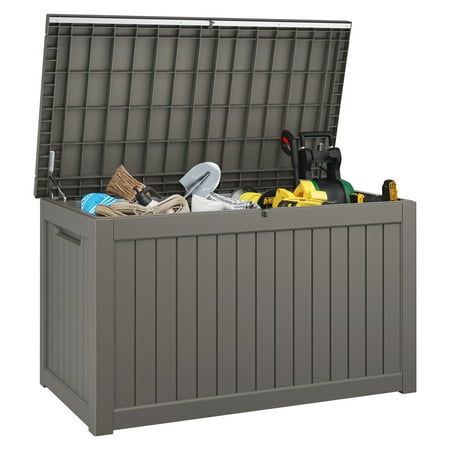 an outdoor storage box is shown with various items in the bins and on the lid