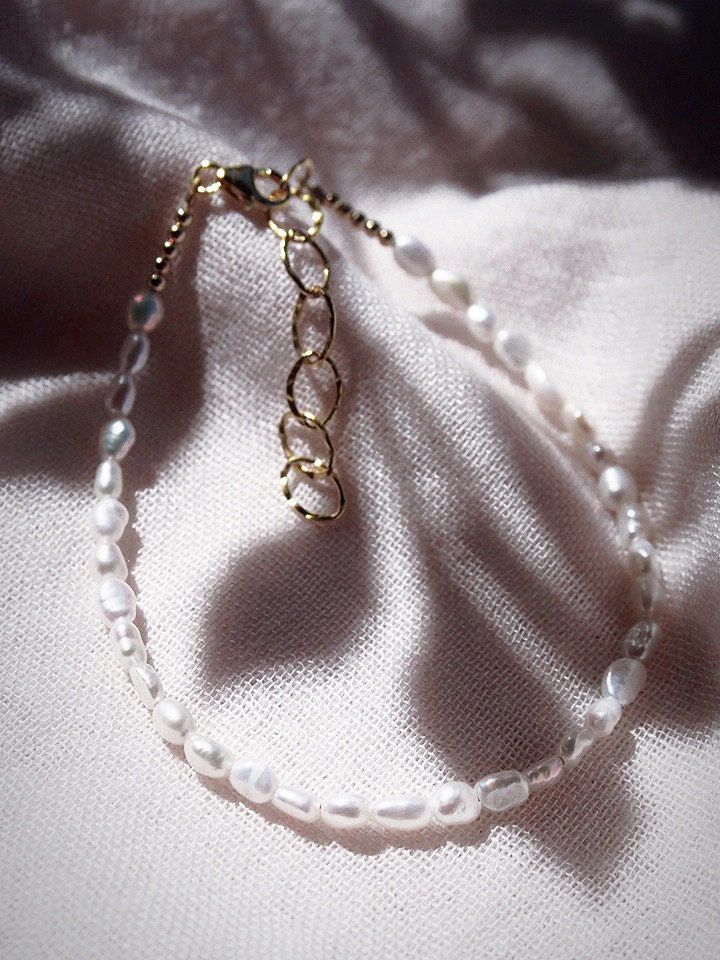 This beaded anklet features a collection of tiny white freshwater pearls to capture the enticement of Hawaii’s white sand beaches. Wear this gold pearl anklet alone or stacked for a classically elegant allure. ✦ DETAILS ✦✧ Name: Maile (MIE-leh) - vine.✧ Adjustable Length up to 10" Inches.✧ White 2-3mm Freshwater Pearls.✧ 14kt Gold Filled Components, Extender, and Clasp.✧ All Ke Aloha Jewelry pieces come packaged thoughtfully, beautifully, and ready for gift giving. Elegant Tiny Beads Pearl Bracelet, Elegant Pearl Bracelet With Tiny Beads, Dainty White Beaded Anklets, Elegant Pearl Beaded Bracelet With Tiny Beads, Elegant Pearl Beaded Bracelets With Tiny Beads, Adjustable White Pearl Anklets, White Pearl Bracelet With Tiny Beads For Wedding, Elegant Pearl Beaded Anklets, White Pearl Wedding Bracelet With Tiny Beads