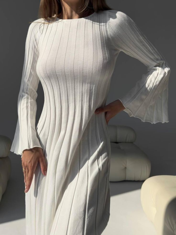 This elegant white dress with an open back is the embodiment of femininity and refined style. It is designed for those who aim to look sophisticated and modern. The open-back design adds a touch of lightness and allure, drawing attention with its delicate charm. Material: The dress is made of high-quality fabric, consisting of a blend of: 50% viscose - provides softness and breathable properties, making the fabric comfortable to wear. 22% nylon - adds durability and elasticity, allowing the dres Elegant Ribbed Mini Dress, Elegant Ribbed Mini Length Dress, Elegant Knee-length Ribbed Mini Dress, Elegant Ribbed Bodycon Dress For Evening, White Mid-length Evening Dress, White Stretch A-line Midi Dress, Summer Long Sleeve Ribbed Midi Dress, White A-line Midi Dress With Stretch, Elegant White Ribbed Bodycon Dress