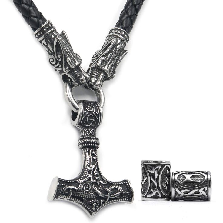 a necklace with an old style hammer on it and two charms attached to the clasp