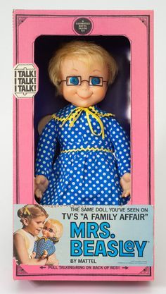 a doll in a pink box with blue glasses