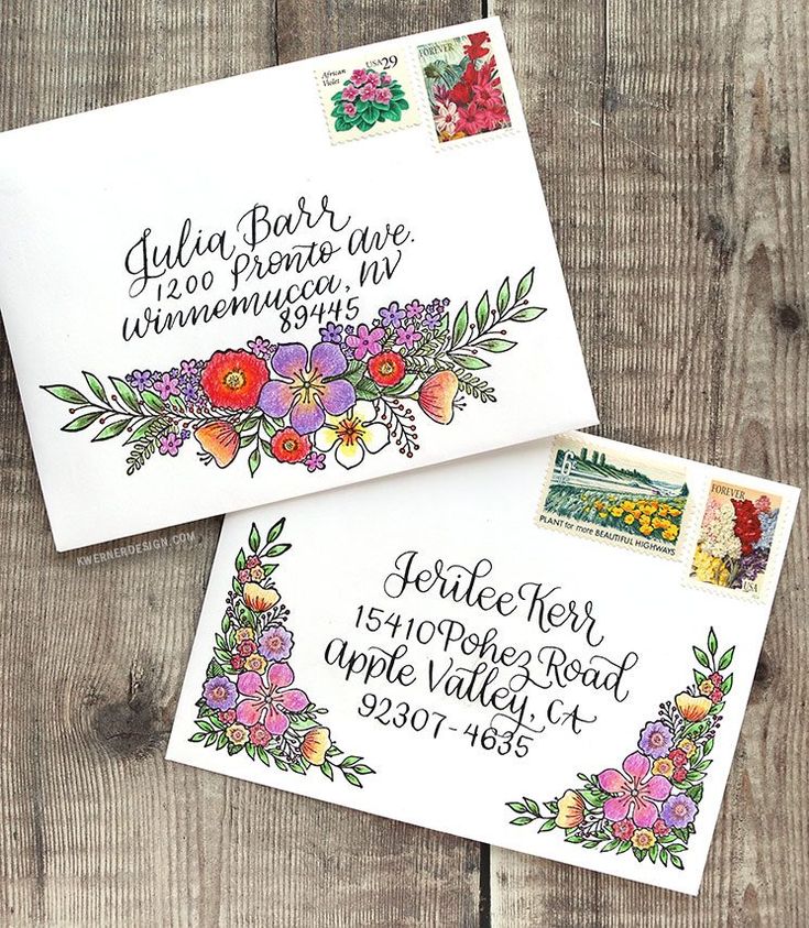 two envelopes with stamps on them sitting next to each other, one is decorated with flowers