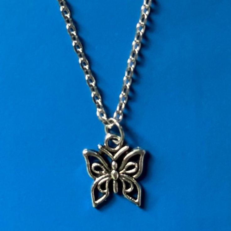 Silver Butterfly Necklace ⭑ Water Safe & Tarnish Free Chain ⭑ Available in 3 Different Lengths ⭑ Chain Material - Stainless Steel ⭑ Charm Dimensions - 14mm x 12mm ⭑ UK SHIPPING - Shipping to the UK is completely free with no minimum spend. ⭑ INTERNATIONAL SHIPPING - Shipping to everywhere else in the world is just £3. Any additional items ordered within the same order are shipped with no extra shipping charge. Handmade Silver Alloy Charm Necklaces, Handmade Silver Charm Necklace In Alloy, Silver Butterfly Necklace With Metal Chain, Silver Chain Metal Charm Necklace As Gift, Silver Butterfly Necklace With Chain, Silver Charm Necklace In Alloy, Silver Alloy Chain Necklace As Gift, Silver Alloy Chain Necklace For Gift, Metal Link Charm Necklace As Gift