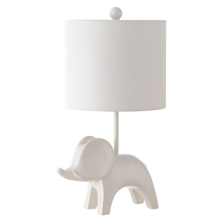 an elephant lamp with a white shade on it's head and trunk is shown in front of a white background