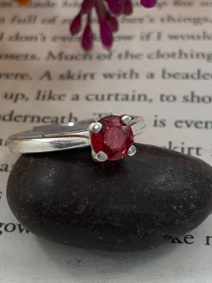 African Ruby hand set in a sterling silver mount.  Ring is size N, however it can be resized depending on your ring size. Please message for more details on resizing. Stone is 5.5 mm at its highest point  The stone is a beautiful striking red  Ring is hallmarked Sterling silver Hallmarked Ruby Ring With Round Band For Anniversary, Hallmarked Ruby Ring For Anniversary, Sterling Silver Solitaire Birthstone Promise Ring, Formal Sterling Silver Birthstone Engraved Ring, Classic Ruby Stackable Rings, Sterling Silver Engraved Ring With Gemstone For Anniversary, Hallmarked Silver Ruby Ring For Anniversary, Classic Sterling Silver Birthstone Ring With Gemstone, Formal Sterling Silver Engraved Ring With Birthstone