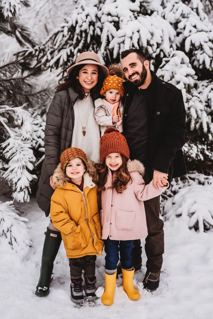 a family posing for a photo in the snow