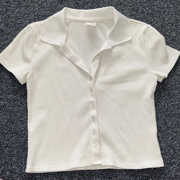 White Collared Button Up Shirt Never Worn. Super Cute To Wear Dressed Up Or Casual Short Sleeve Button Up Shirt Women, Cute White Button Up, White T-shirt With Button Closure For Spring, White Button Closure Polo Shirt For Summer, Spring Collared T-shirt With Button Closure, Collared T-shirt With Button Closure For Spring, Spring Short Sleeve Polo Shirt, White Buttoned Polo Shirt For Summer, White Short Sleeve Polo Shirt With Button Closure