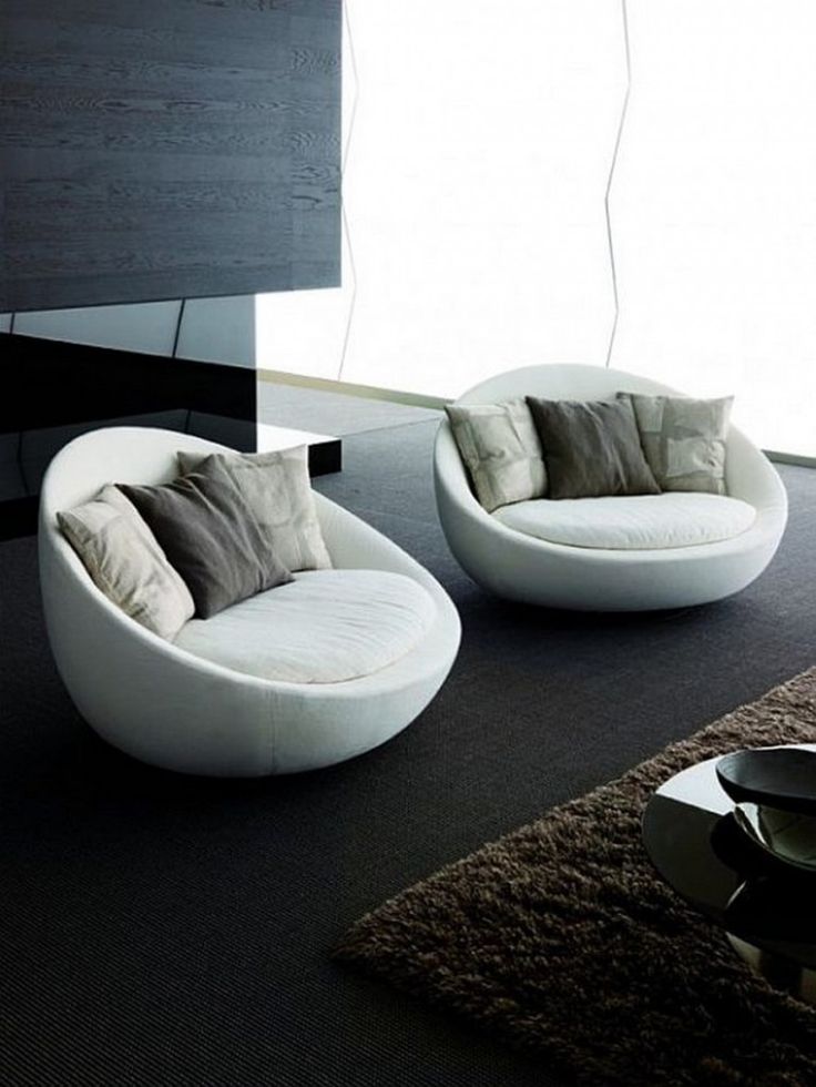 two white chairs sitting on top of a carpeted floor