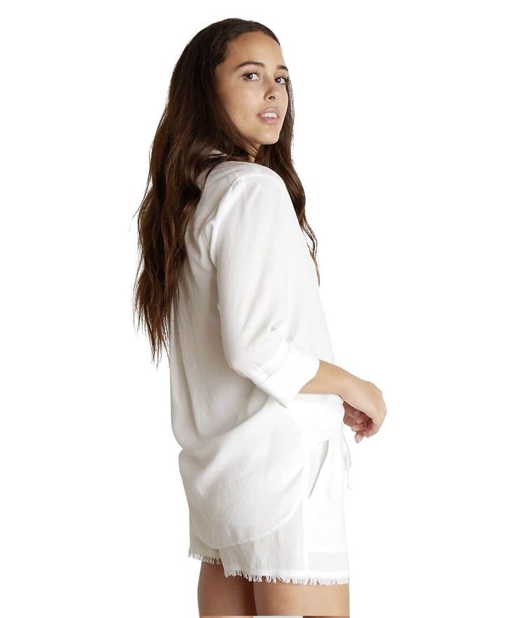 This classic button down is a supersoft, lightweight fitting fabric. The Shirt Tail Button Down is detailed with a front pocket and pleated back. Roll the sleeves for a casual look and pair with sandals or heels. 100% Tencel 100% Tencel Machine wash cold Front button closure Chest pocket Shirt tail hemline Approx. 38" chest, 26 1/2" shoulder to hem (size small) Model is 5'10" and wearing a size small