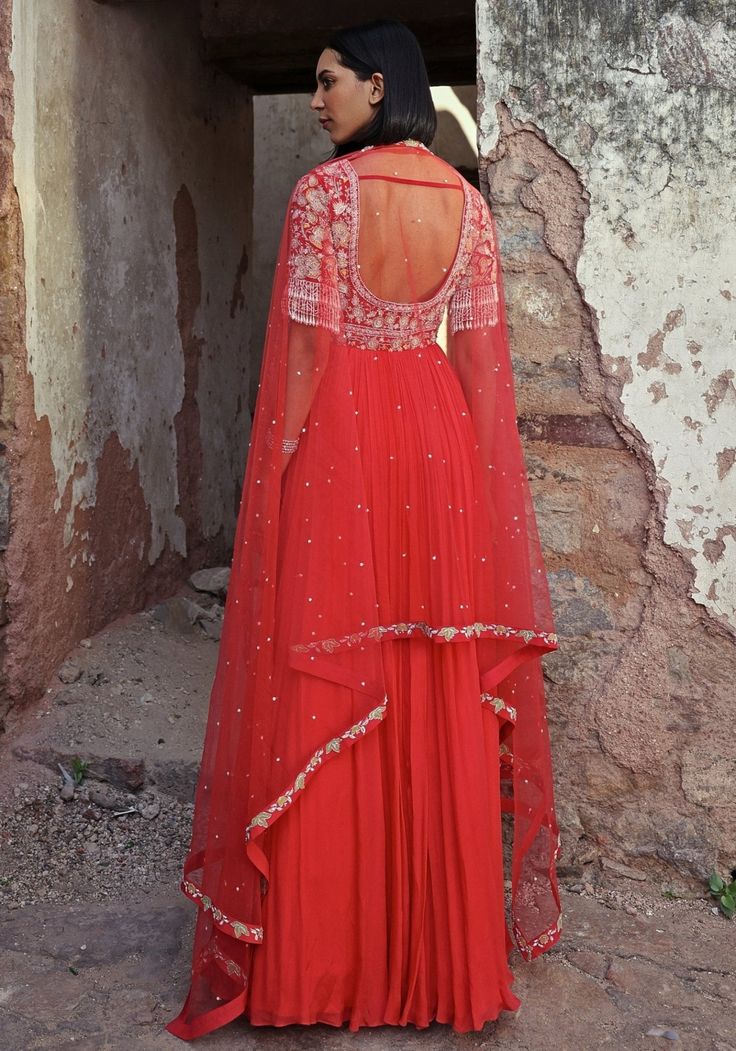 Step into elegance with the Coral Pink Anarkali. Made from georgette and chiffon, this full-length beauty features an exquisitely embellished bodice adorned with sequins, pearls, glass beads, zari, and flower applique. Completed with a soft net dupatta this Anarkali is ideal for making a statement at Mehendi and Sangeet ceremonies or as a standout wedding guest outfit. Composition : Anarkali - Georgette & Chiffon, Dupatta - Net, Satin lining Care: Dry Clean Only and Vacuum Storage This product can be customized for sleeves, length and colour Delivery : 4-6 weeks as the product is hand crafted. Check Size Guide or choose MySize for free customisation (All Sizes above XL can be made at 15% additional cost) For more information and sizes please contact fabiliciousfashion@gmail.com or visit ou Anarkali Georgette, Floral Anarkali, Pearl Tassels, Coral Outfit, Pink Anarkali, Beauty Features, Vacuum Storage, Indian Wedding Wear, Chiffon Dupatta