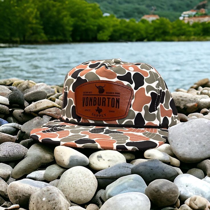 The new Salmon Creek Duck Duck Camo Rope Leather Patch Hat. More custom duck camo leather patch hats on website slong with Richardson and Yupoong custom hats. Blanks available on website. Custom hats made in Texas. www.vonburtonsupplyco.com Please upload your logo with your order Brown Curved Brim Snapback Hat For Travel, Brown Hats With Leather Patch For Outdoor Activities, Brown Trucker Hat With Short Brim For Outdoor Activities, Brown Trucker Hat With Curved Brim For Travel, Brown Snapback Hat For Travel, Brown Short Brim Hat For Camping, Brown Short Brim Baseball Cap For Outdoor, Brown Flat Bill Hat For Camping, Brown Snapback Hat With Short Brim For Outdoor