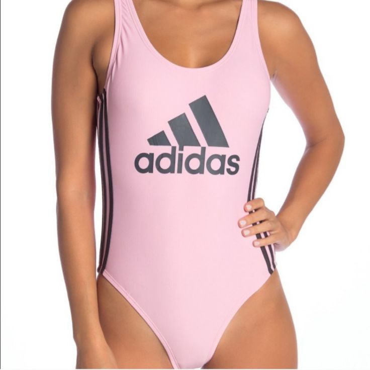 New With Tags Adidas One-Piece Swimsuit With A Low Cutout Back. Solid Pink With Grey Adidas Logo Front Center And 3-Stripe Sides. Nylon And Spandex With Polyester Lining. No Damage Or Defects. Smoke And Pet Free Home. Pink Athleisure Bodysuit For Sports, Sporty Pink Bodysuit For Sports, Pink Sporty Bodysuit For Sports, Sporty Pink One-piece Swimwear, Sporty One-piece Pink Swimwear, Casual Pink Workout Bodysuit, Casual Pink Bodysuit For Workout, Sporty Pink Bodysuit For Summer, Spring Workout Pink Bodysuit