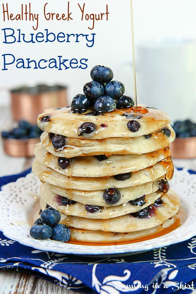 a stack of pancakes topped with blueberries and syrup on top of a white plate