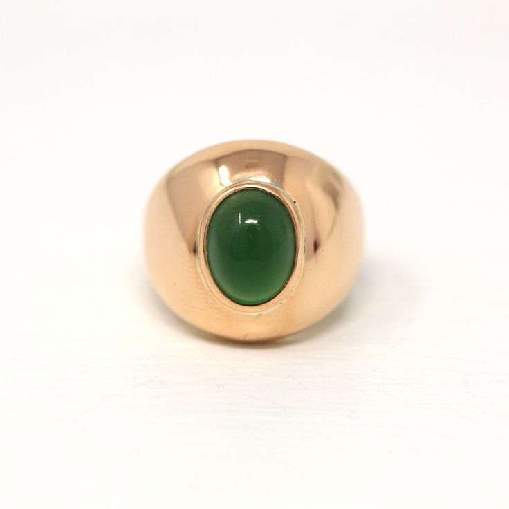 Incredible vintage circa 1970s era 14k rose gold green stone ring! This gorgeous statement ring features an oval cabochon cut green glass stone, that is securely bezel set. A fantastic piece of fine vintage jewelry, featuring a beautiful green glass stone!    ERA - Circa 1970s - Retro  METAL / MATERIAL - 14k rose gold, glass MARKINGS / HISTORY - There are no markings, but this piece has been professionally tested.  CONDITION - Good vintage condition. Rose gold metal has been professionally polis 70s Jewelry, Green Stone Ring, Green Stone Rings, Rose Gold Metal, Gold Glass, Metal Material, Green Stone, Oval Cabochon, Stone Ring