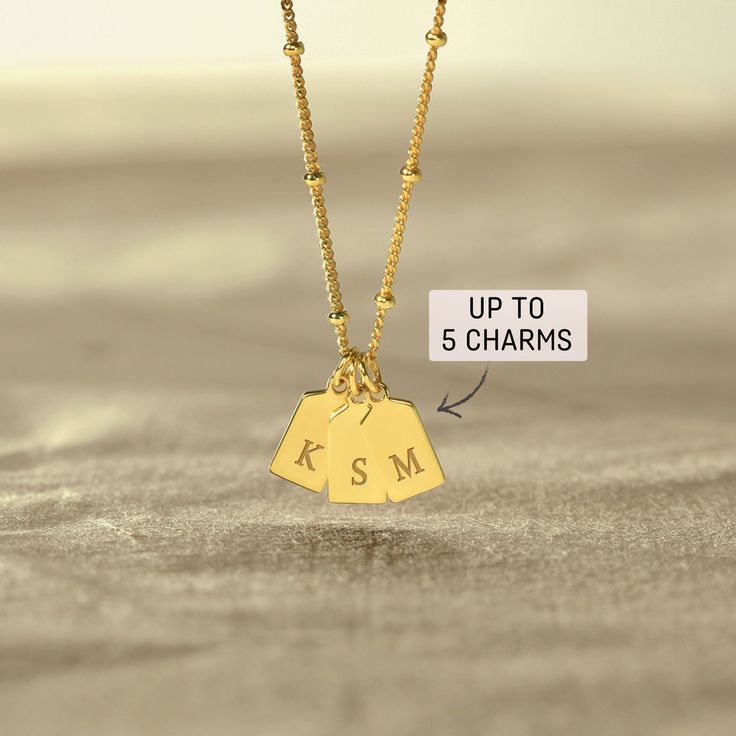 A mom necklace with kid initials is a beautiful and sentimental piece of jewelry that features the names of a mother's children. This necklace is a special way for a mother to keep her children close to her heart at all times.. P R O D U C T ∙ I N F O * Finishing: Silver - Yellow Gold - Rose Gold * Necklace length: Up to 24 inches (excluding pendant's length) * By default, silver items comes with BLACK engraving and gold-plated item comes with CLEAR engraving * Up to 5 charms H O W * T O * O R D Birthday Charm Necklaces For Valentine's Day, Valentine's Day Birthday Charm Necklaces, Birthday Charm Pendant Necklaces, Birthday Charm Pendant Necklace, Personalized Dainty Charm Necklace For Mother's Day, Dainty Personalized Charm Necklaces For Mother's Day, Sterling Silver Name Necklace With Charms For Mom, Mother's Day Birthstone Charms For Gifts, Dainty Charm Necklace For Birthday