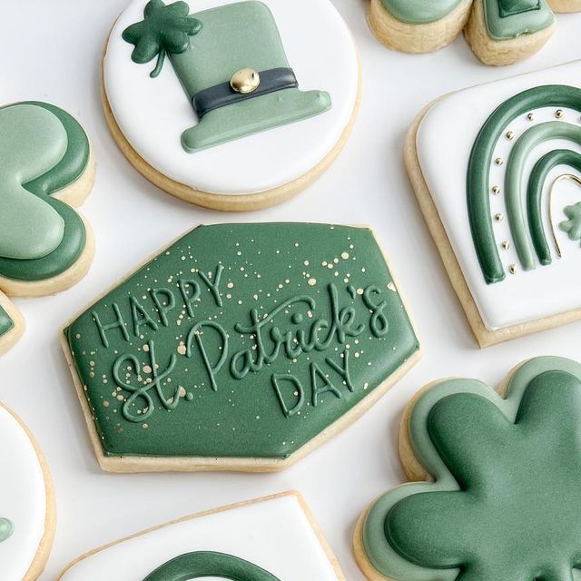 cookies decorated with green icing and shamrock decorations