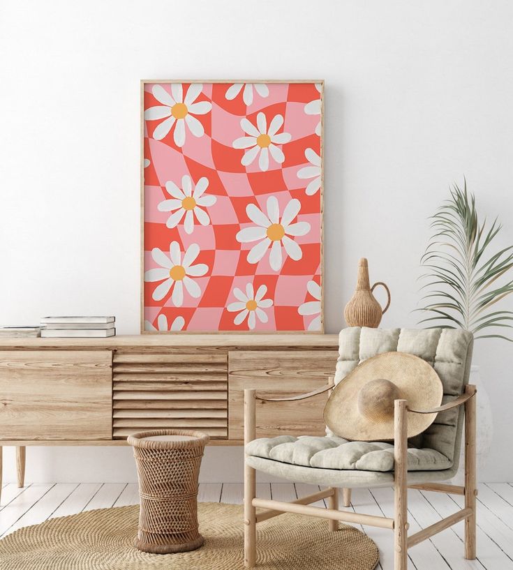 a living room with a chair, table and flower painting on the wall above it