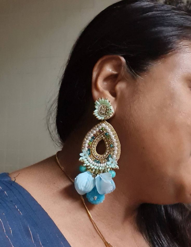 "Bohemian handmade statement turquoise blue embellished large earrings. These beautiful turquoise earrings are hand crafted beautifully using various material like fabric, glass, chatton,pompoms etc. An ideal summer party earrings The rarrings measure about approx. 3.80\" long and 2.20\" wide. Each beautiful Carnation jewellery piece is handcrafted in India and ship from India. Please note, Since our product is purely handmade in nature hence a slight imperfection may be there. But I try and mak Bohemian Blue Flower Earrings, Handmade Light Blue Drop Flower Earrings, Bohemian Blue Teardrop Flower Earrings, Blue Bohemian Teardrop Flower Earrings, Blue Teardrop Bohemian Flower Earrings, Bohemian Drop Flower Earrings For Festive Occasions, Bohemian Flower Drop Earrings For Festive Occasions, Bohemian Blue Earrings For Party, Handmade Bohemian Flower Earrings For Party