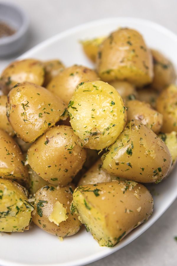 a white plate topped with potatoes covered in seasoning