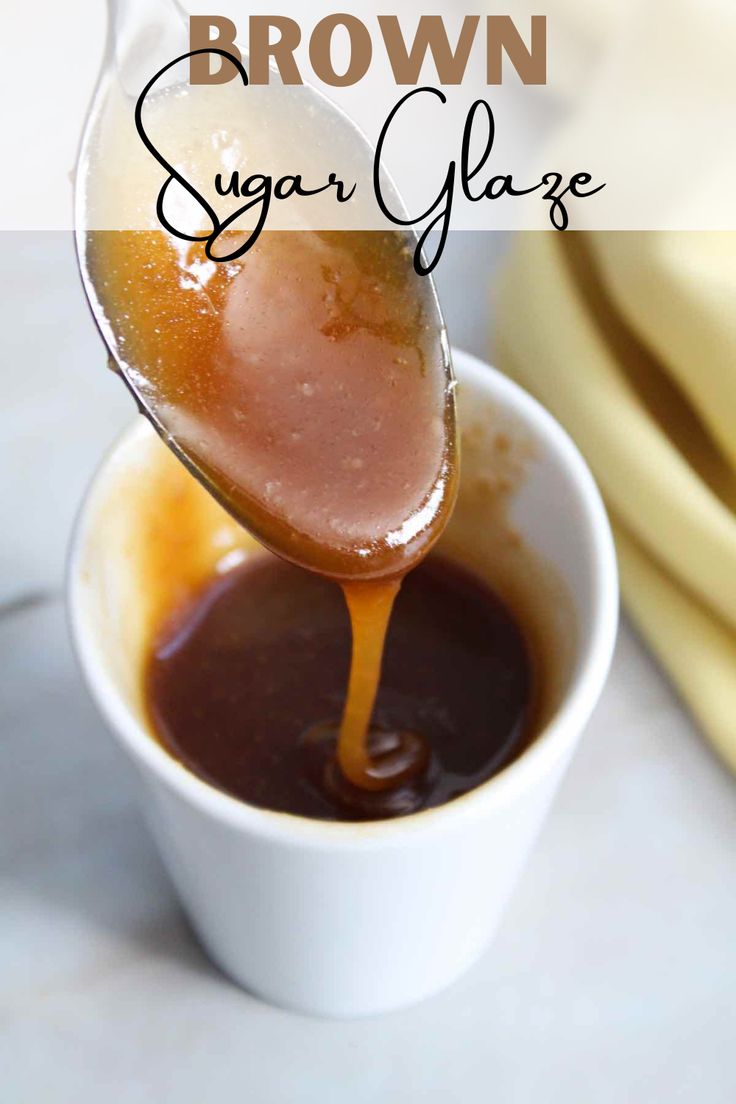 a spoon full of brown sugar glaze being poured into a cup