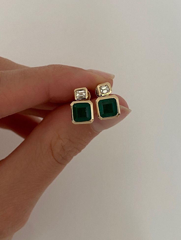 DETAILS: - Approx. 2 carats of emeralds - .28 carats of emerald cut diamonds  - set in 14k yellow gold Panna Ring, Emerald Studs, Bezel Bracelet, Diamond Huggies, Emerald Earrings Studs, Swirl Ring, Heart Dangle Earrings, Emerald Earrings, Emerald Cut Diamonds