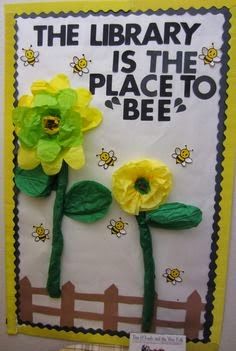 the library is the place to be bulletin board with paper flowers and bees on it