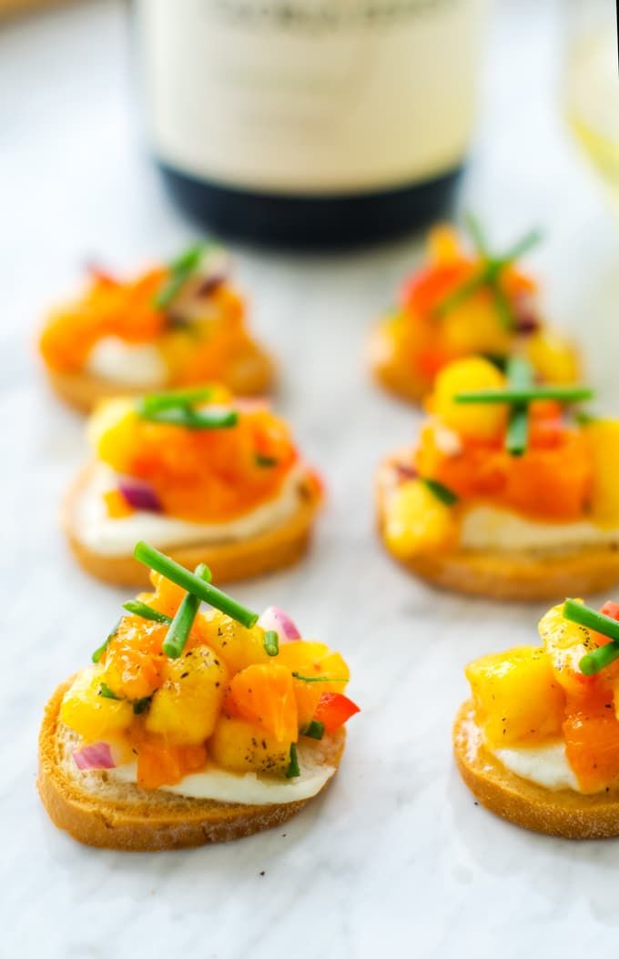 small appetizers are arranged on top of bread