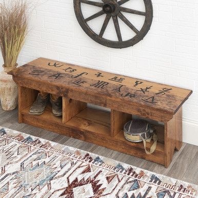 a wooden bench sitting on top of a rug next to a wall mounted clock with chinese writing