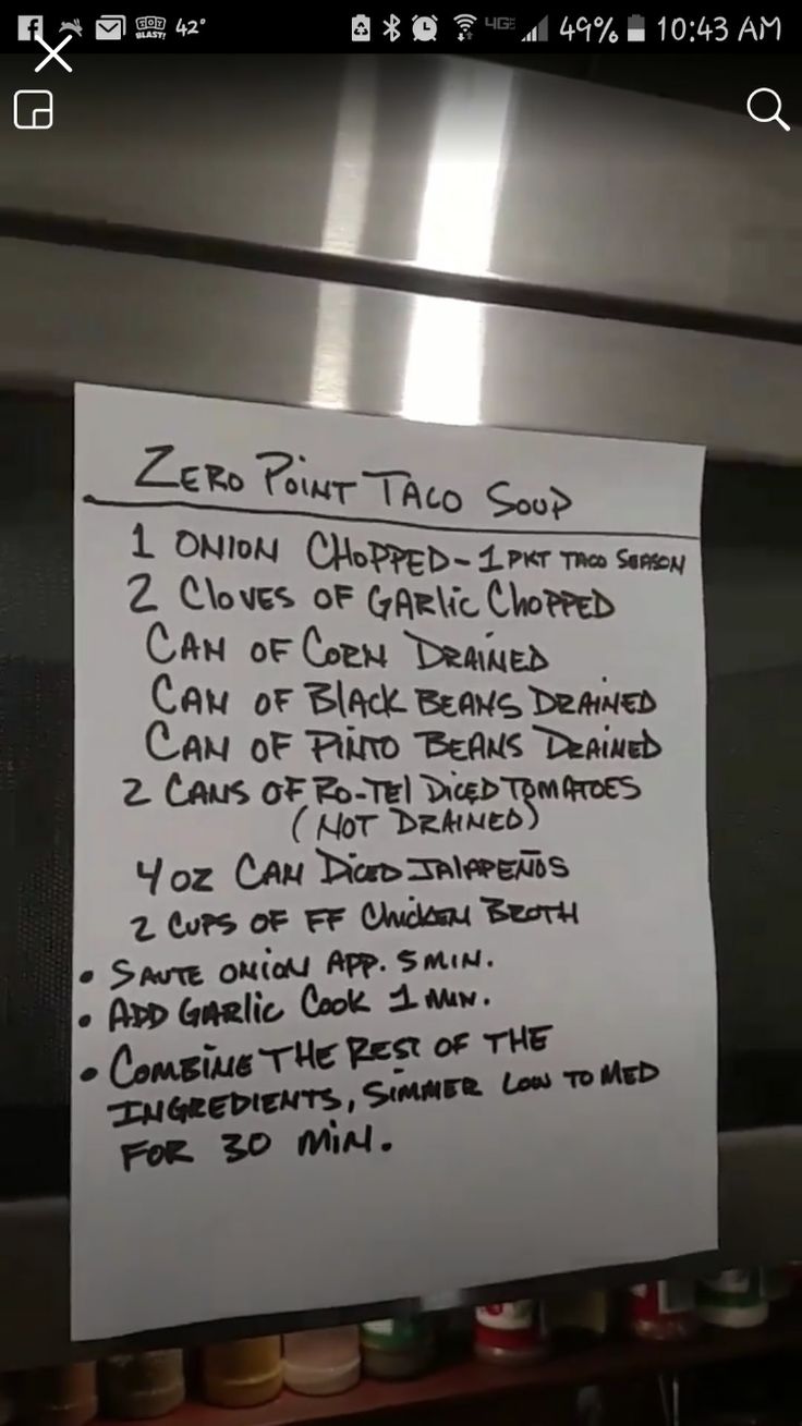 a sign posted on the side of a stainless steel oven door that says zero point taco