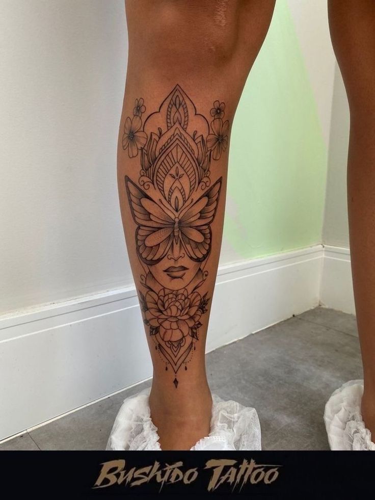 a woman's legs with tattoos on them