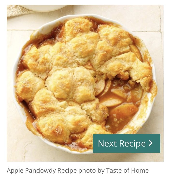 an apple pie in a white bowl next to a cup of coffee