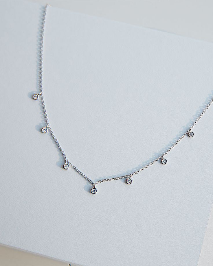 - Made in Sterling silver set with a high-quality Cubic Zirconia. - Stone size: 2.50 mm- Chain length : 15 inch Sterling silver925 Sterling Silver is an alloy made of 92.5% pure silver and 7.5% copper. We plate our silver jewelry in rhodium, which gives it extra shine and durability. Rhodium is one of the costliest precious metals due to its rarity.CareH2O sensitive. Avoid water when wearing your piece, because over time the sterling silver will oxidize.However, the oils in your skin help keep s Dazzling Sterling Silver Diamond-cut Jewelry, Dazzling Diamond Cut Sterling Silver Jewelry, Fine Jewelry Silver Round Cut Diamond Necklace, Silver Pendant With Diamond Cut, Sterling Silver Round Pendant With Diamond Accents, Sterling Silver Jewelry With Diamond Accents Round Pendant, Silver Pendant Jewelry With Diamond Cut, Silver Diamond-cut Necklace, Silver Diamond Cut Pendant Jewelry