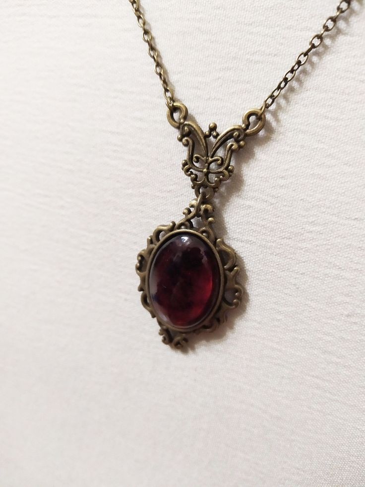 ◆ Victorian style necklace. The red blood cabochon size is 0.984252 x 0.708661 inches and it was completely handmade in resin. The inserts, the base and the chain are in bronze, The product is made by hand with great care. ♡ In my shop there are many handmade jewelry for all tastes, come and watch them are welcome! ♡ Red Amulet Necklace, Victorian Era Necklace, Victorian Style Necklace, Antique Ruby Necklace For Formal Occasions, Red Garnet Oval Pendant Necklace, Victorian Oval Necklaces With Antique Finish, Victorian Round Necklace With Antique Finish, Victorian Oval Necklace With Antique Finish, Antique Oval Cabochon Gemstone Necklaces