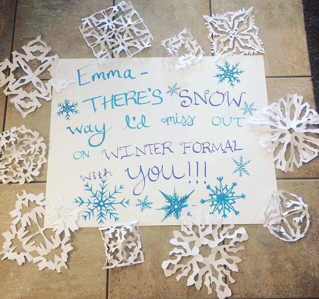 paper snowflakes are on the ground with a sign