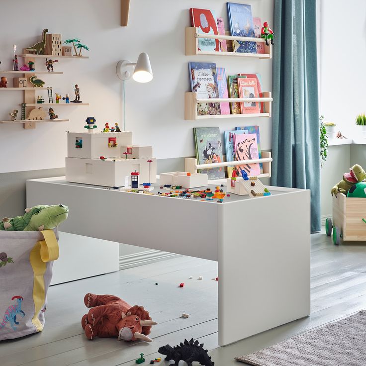 a child's playroom with toys and books on the shelves in front of it