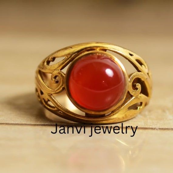 Carnelian Ring, gemstone ring, statement ring, handmade ring, brass ring, unique ring, gift for her, anniversary ring, wedding ring, promise Gemstone carnelian Jewelery Category:- Handmade Ring Metal:-Brass -- T H E * Q U A L I T Y We buy raw gemstones directly from miners and then get them cut and polished at our workshop , Therefore saving some bucks (additional added fees and markups) avoiding a middle man and making sure of the authenticity of the gems. And we use top quality materials that are water safe (ideally) However it is highly recommended to avoid water since doing so will prolong the durability and quality of your jewelry. Also, we recommend avoiding contact with chemicals such as bleach, perfume and sunscreen because they can damage the material over time which will affect i Unique Hallmarked Ruby Promise Ring, Elegant Handmade Ruby Promise Ring, Unique Open Ruby Promise Ring, Heirloom Amber Round Rings, Antique Style Toe Ring As Gift, Yellow Gold Carnelian Wedding Jewelry, Vintage Cabochon Moonstone Ring For Promise, Brass Crystal Wedding Ring, Heirloom Style Dome Ring With Cabochon For Gift