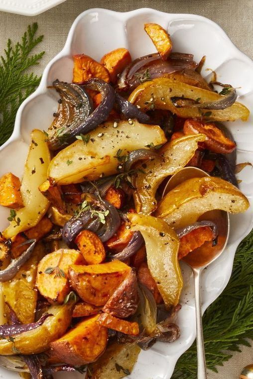 a white bowl filled with cooked vegetables on top of a table