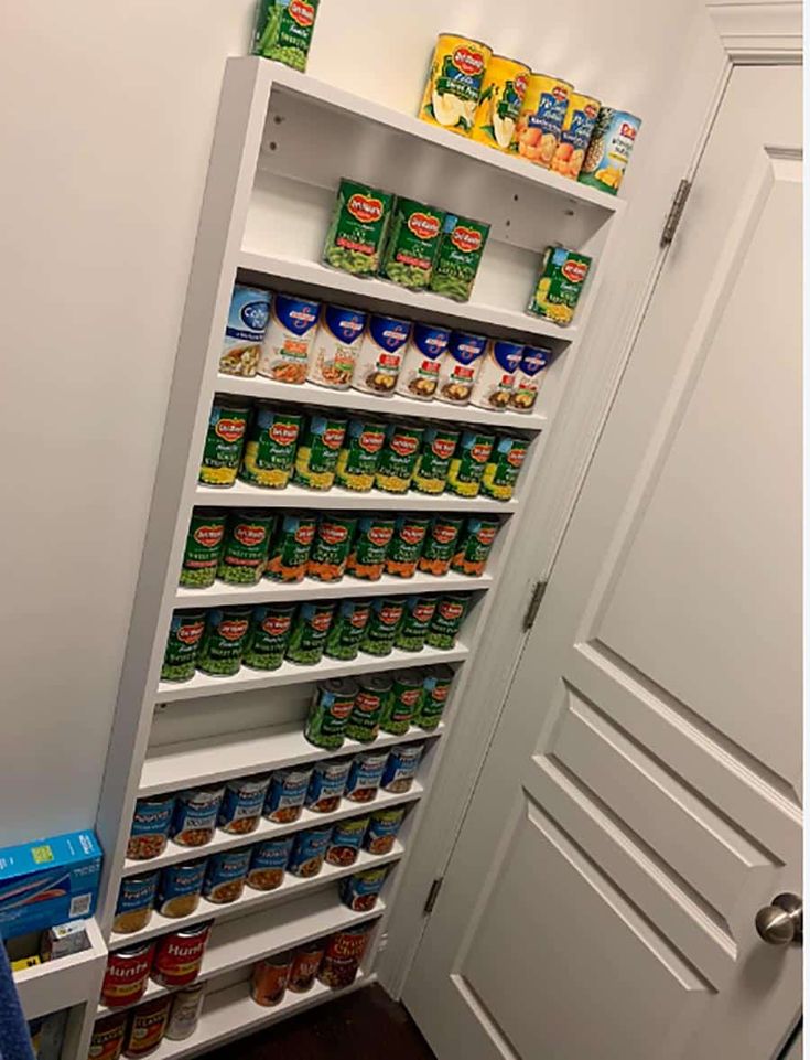 an open pantry with canned food in it