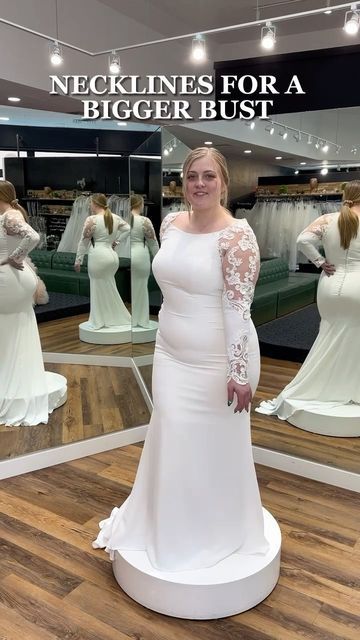 a woman standing in front of a mirror wearing a white dress