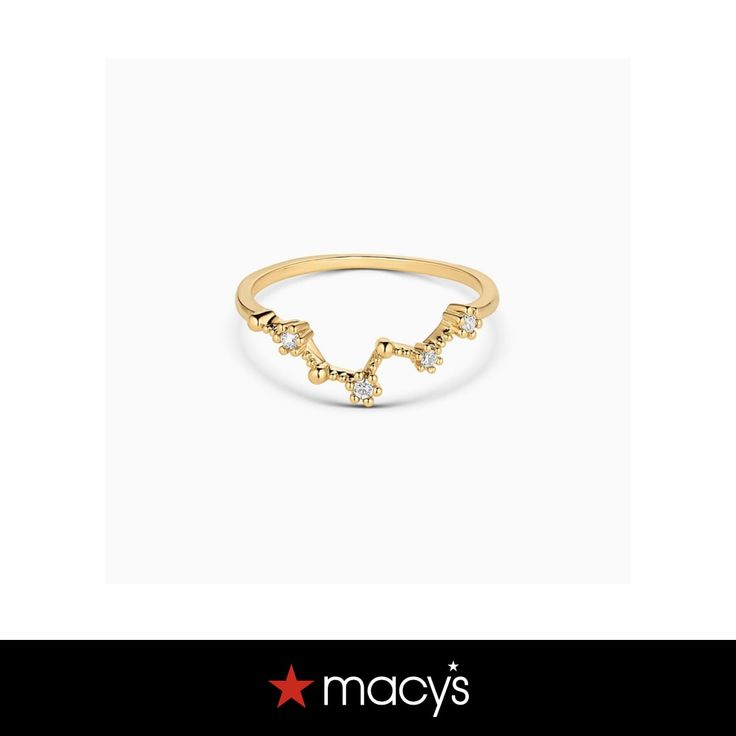 a gold ring with stars on it and the words macy's written in white letters