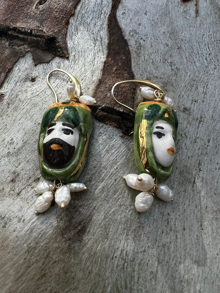 Sicilian earrings with hand-painted ceramic with fine gold touches Mounted in brass with Mediterranean coral and river pearls Hand Painted Gold Polymer Clay Earrings, Unique Hand Painted Polymer Clay Earrings, Green Artisan Enamel Earrings, Artisan Green Enamel Earrings, Handmade White Enamel Earrings, Handmade Yellow Gold Enamel Jewelry, Unique Enamel Earrings For Gift, Handmade Bohemian Pearl Earrings As Gift, Handmade Green Pearl Earrings For Gift