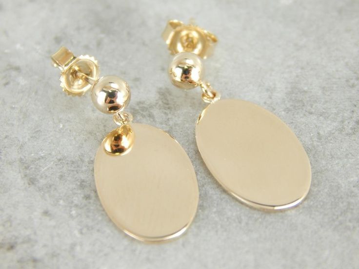 Beautifully polished and simple as can be in design. These gleaming yellow gold drops were adapted from a pair of antique cufflinks, and hung from simple stud earrings. Metal: 14K Yellow Gold Earrings Length: 22 mm Earring Width: 9 mm Marks: "14K" Stamped on the findings Timeless Oval Tarnish Resistant Earrings, Timeless Oval Tarnish-resistant Earrings, Timeless Oval Earrings With Shiny Finish, Formal Oval Link Earrings With Polished Finish, Formal Oval Link Polished Earrings, White Gold Oval Earrings Tarnish Resistant, Oval White Gold Earrings Tarnish Resistant, Oval White Gold Tarnish-resistant Earrings, Classic Oval Earrings, Tarnish Resistant