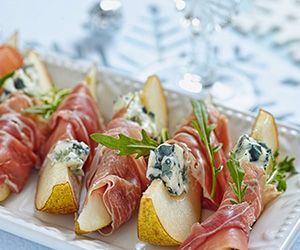 several appetizers are arranged on a white platter