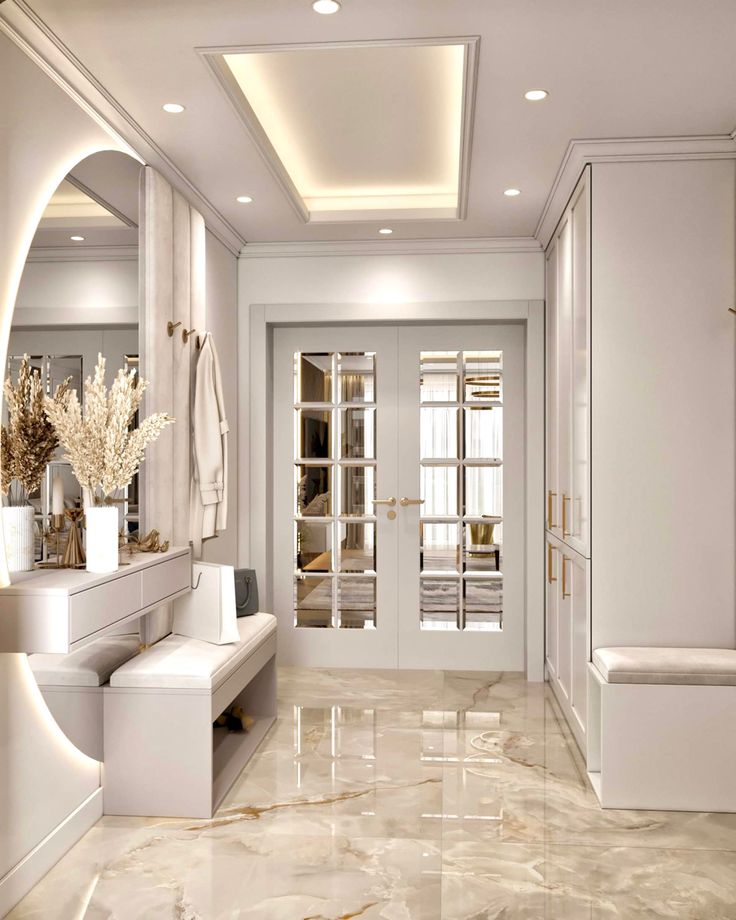 an elegant bathroom with marble floors and white walls, along with large mirrors on the wall